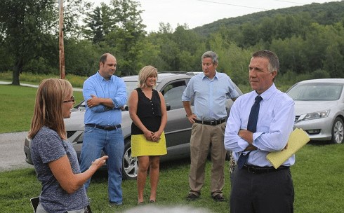 RIDGELINE DEFENDERS: Local resident Christine Lang and Republican gubernatorial candidate Phil Scott discuss their opposition to a proposal to build seven giant wind turbines on Rocky Ridge behind them.